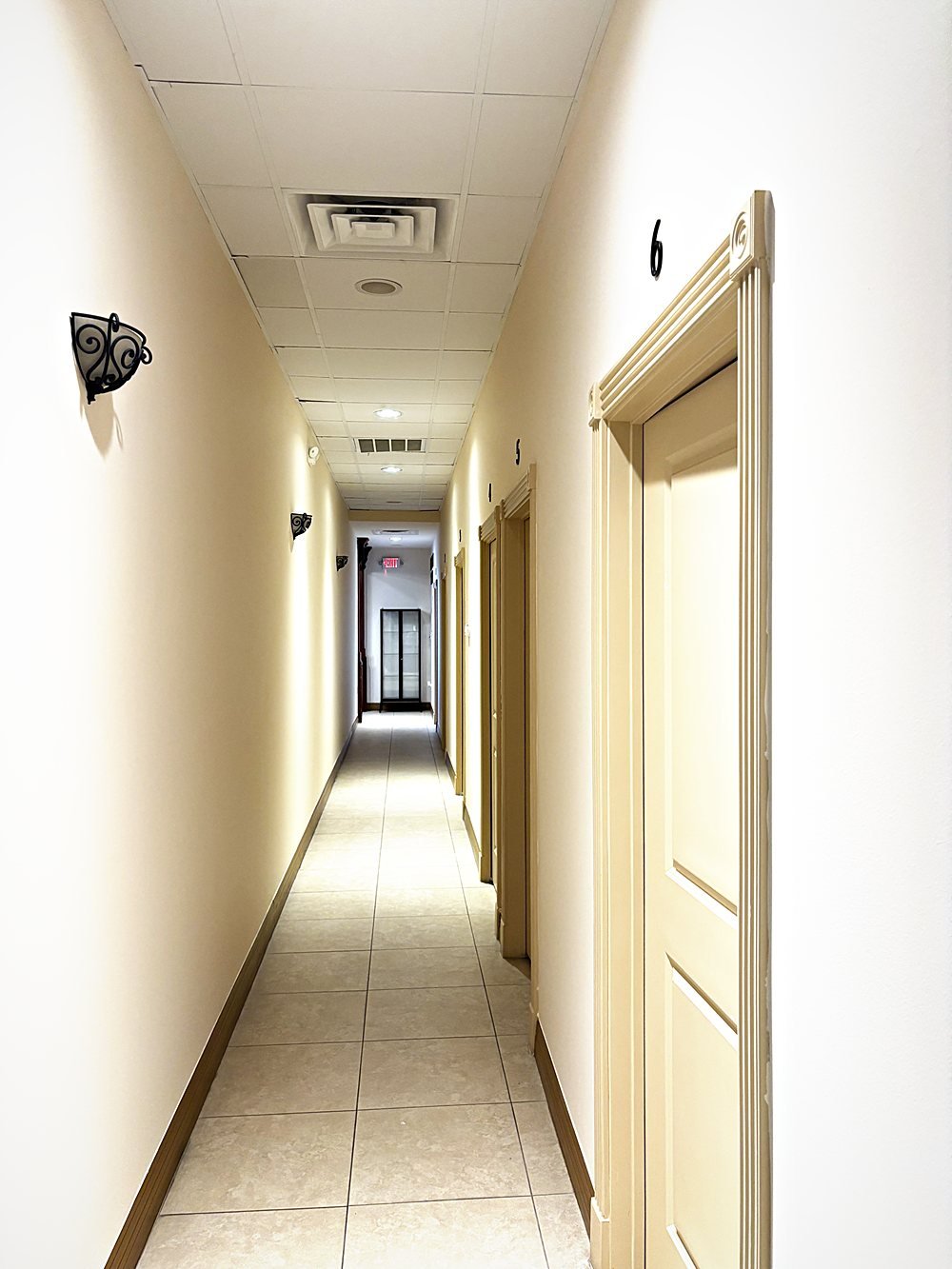 Corridor of six private beauty suites, each with its own door